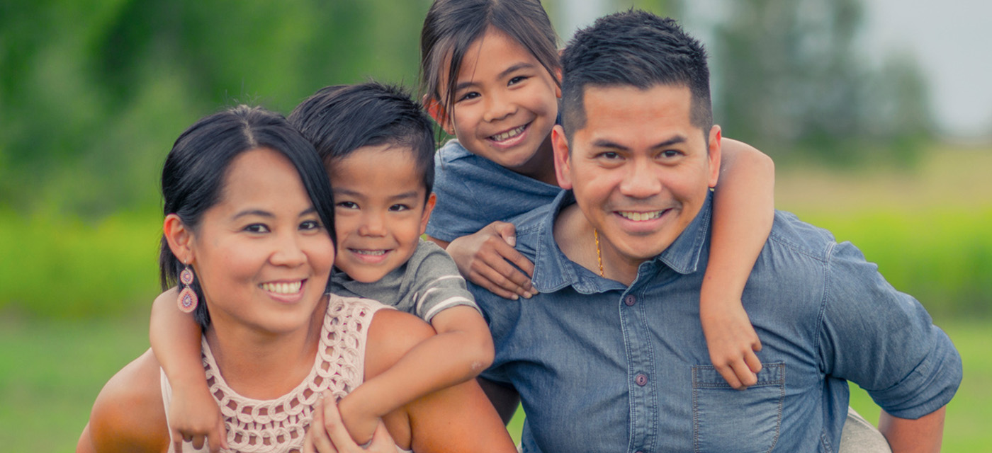 Smiling family looking at the camera.